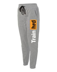 a pair of grey open bottom sweatpants with the Train Hard decal on the left pant leg