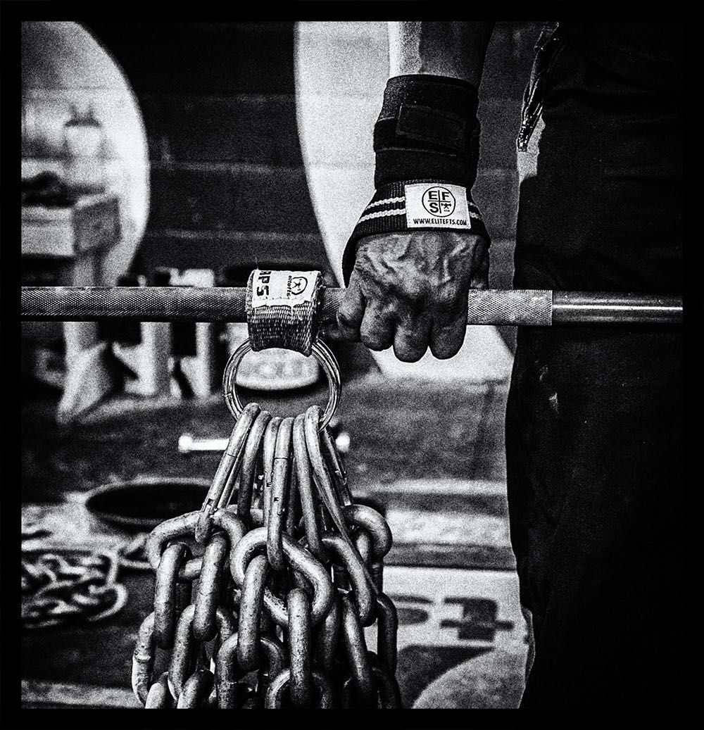 black and white photo of deadlifter using elitefts wrist straps