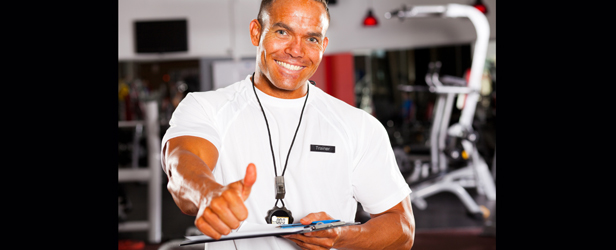 male gym trainer giving thumb up