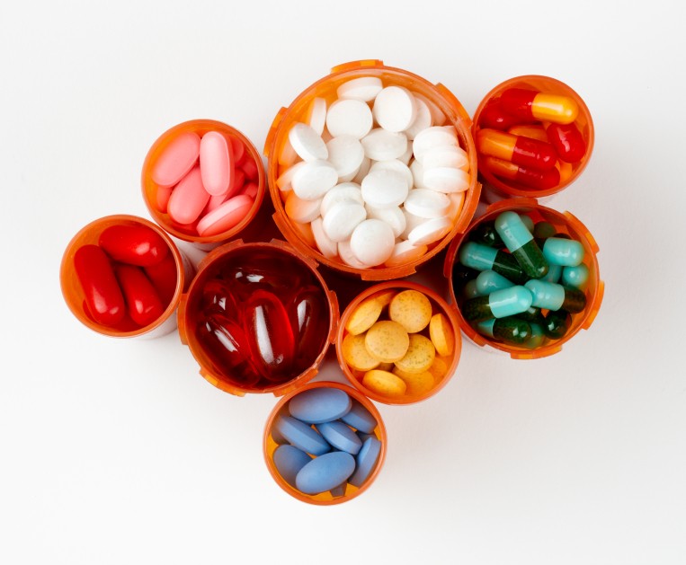 Prescription bottles filled with colorful medications