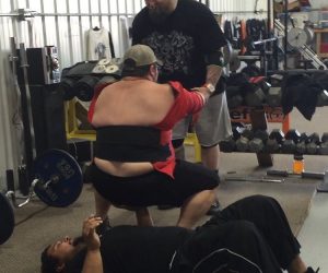 Nate anchors his hand in while benching Walter for charity video
