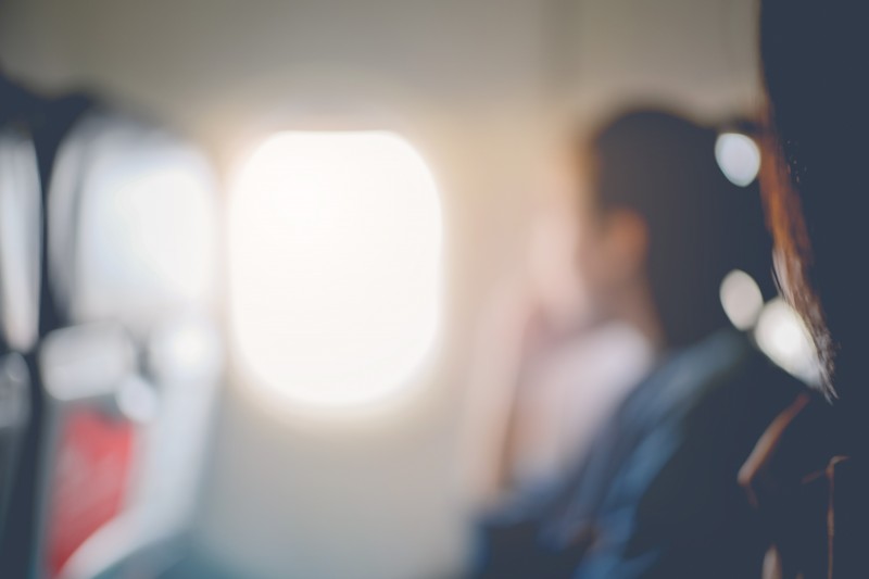 Abstract blur of woman looks out the window