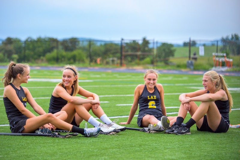 Four Girls Chat at Dusk After Lacrosse Practice