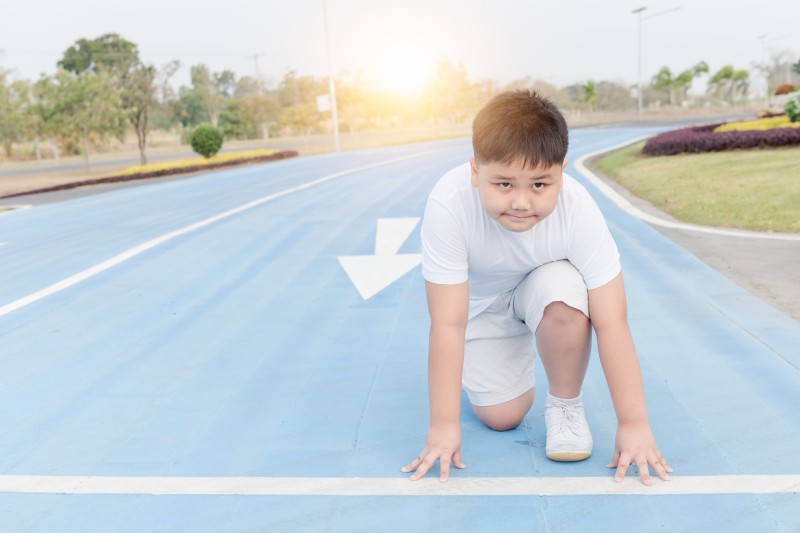 fit and confident boy in starting position ready for running