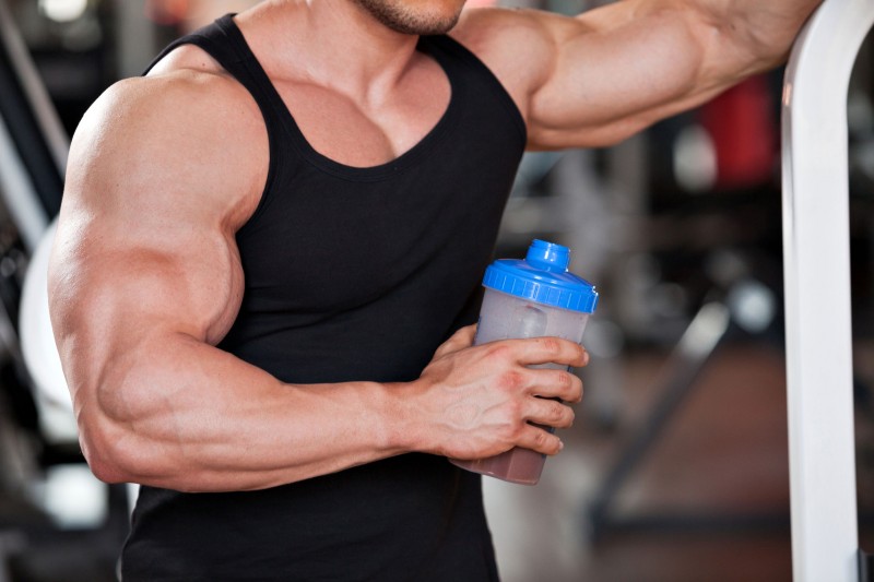 35086333 - young professional bodybuilder in the gym, drinking a protein shake