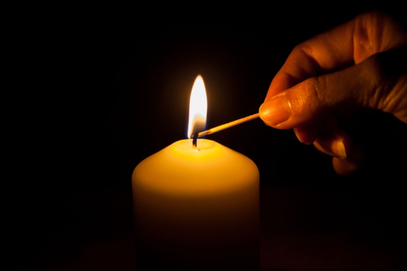 39015271 - hand with matchstick, lighting a candle