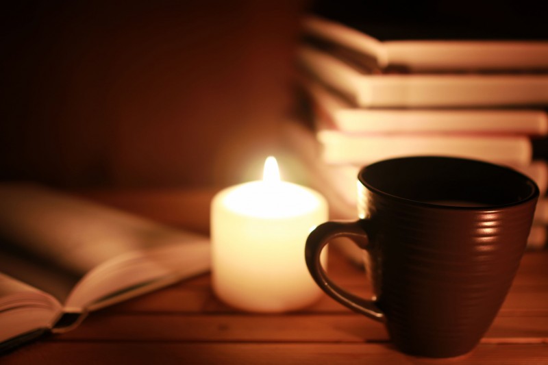 64508808 - book and cups on a table with candle
