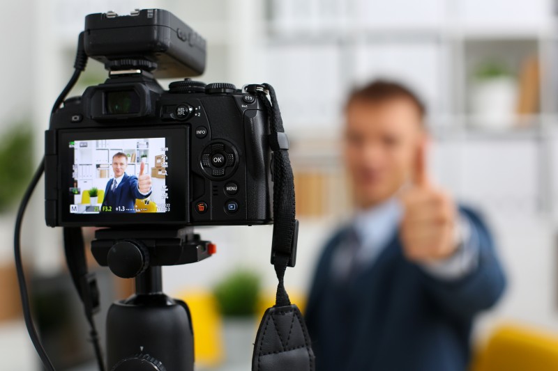 Male in suit and tie show confirm sign