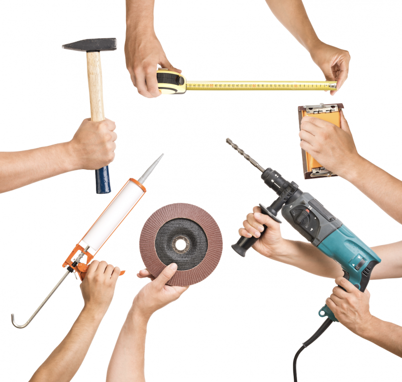  Various tools in a man's hand.