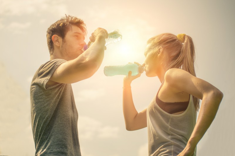 Couple drink water after running