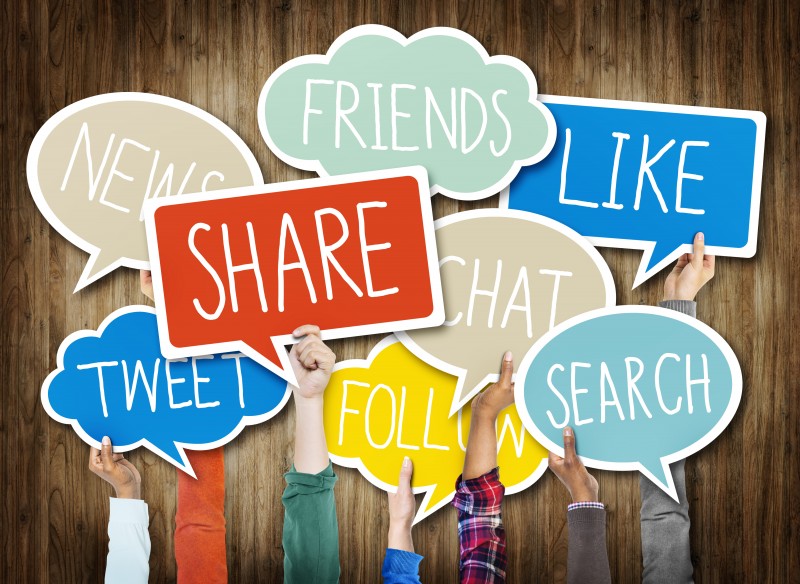 Hands Holding Speech Bubbles with Social Media Words