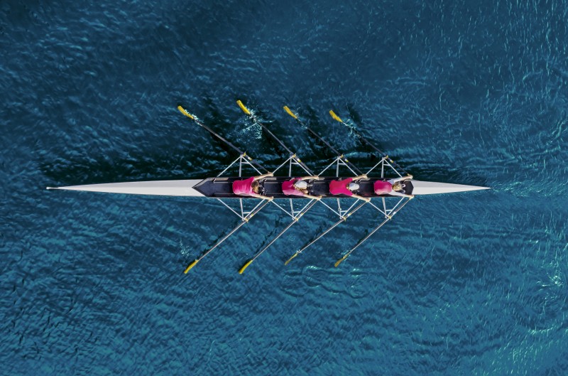 Women's rowing team on blue water