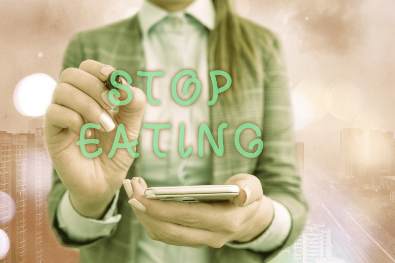 Text sign showing Stop Eating. Conceptual photo cease the activity of putting or taking food into the mouth.