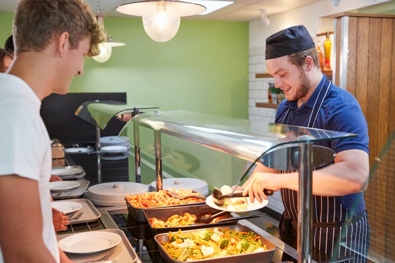 Students-Being-Served-Meal-In-School-Canteen